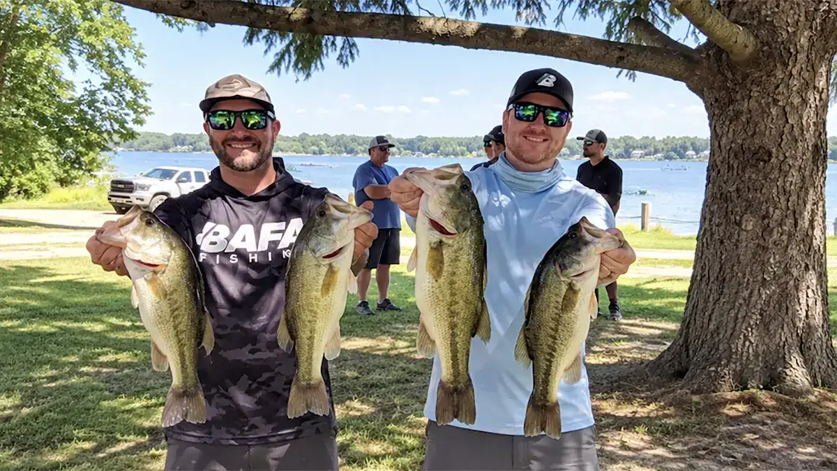 Kris Iodice and Billy Mathews hold up the four biggest bass from their 13.69-pound winning bag at a SMAC club tournament on Diamond Lake.